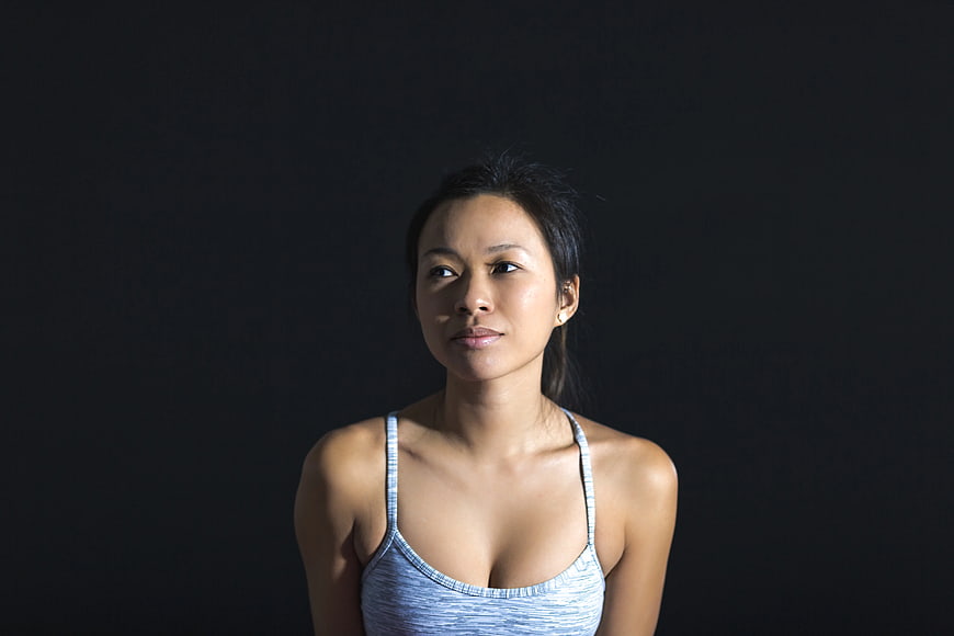 Portrait of Asian Woman in Gray Tank Top on Black Background