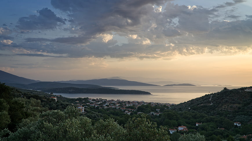 Scenic coastal village landscape at sunset with dramatic clouds