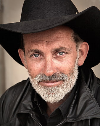 Portrait of mature man with beard and black cowboy hat