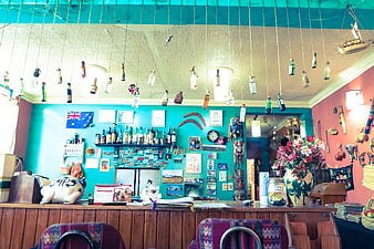 Eclectic bar interior with hanging bottles and vibrant decor