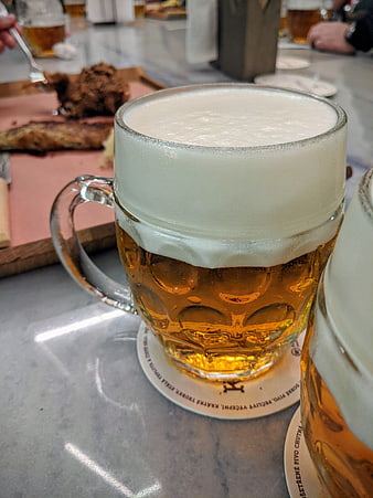 Close-up of frothy pilsner beer in a glass mug