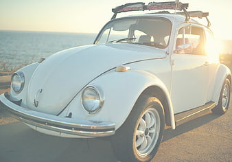Vintage White Volkswagen Beetle at Sunset by the Ocean
