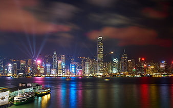 Hong Kong skyline at night with colorful city lights reflecting on the water