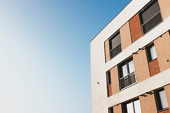 Modern Apartment Building Facade Against Blue Sky