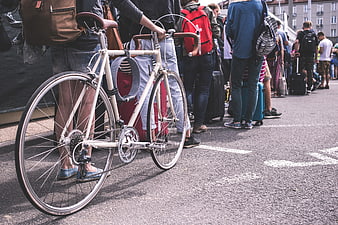 Vintage Bicycle in Crowd with Luggage on Street