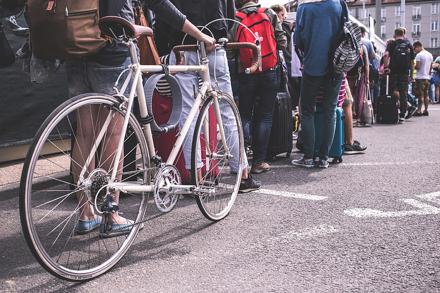 Vintage Bicycle in Crowd with Luggage on Street