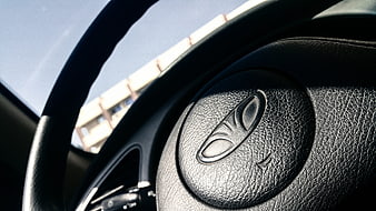 Close-up of Chrysler steering wheel with logo