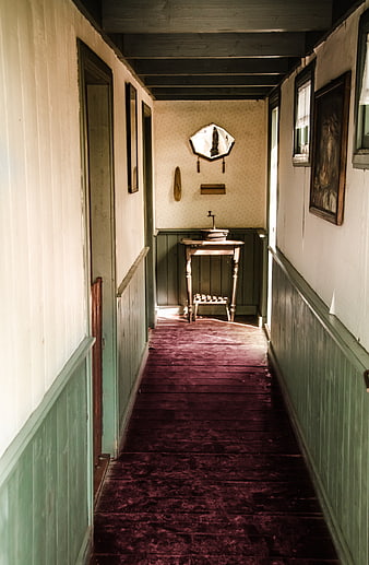 Vintage hallway with purple carpet and antique washstand