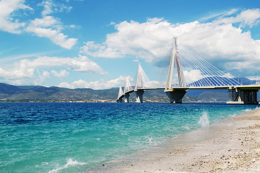Ribbon Bridge over turquoise sea with mountains and blue sky
