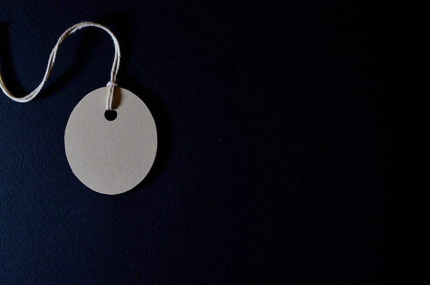 Blank Round Paper Tag With String On Dark Navy Background