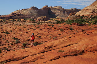 Woman hiking on red rock desert landscape