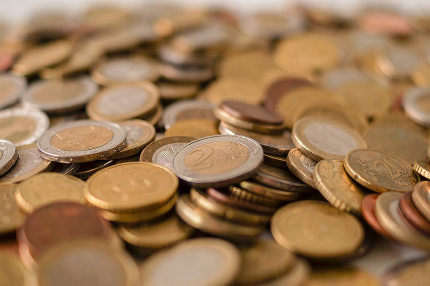 Close-up of mixed Euro coins pile with shallow depth of field