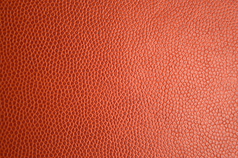Close-up of textured orange leather surface background