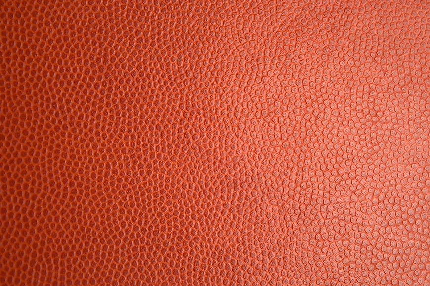Close-up of textured orange leather surface background