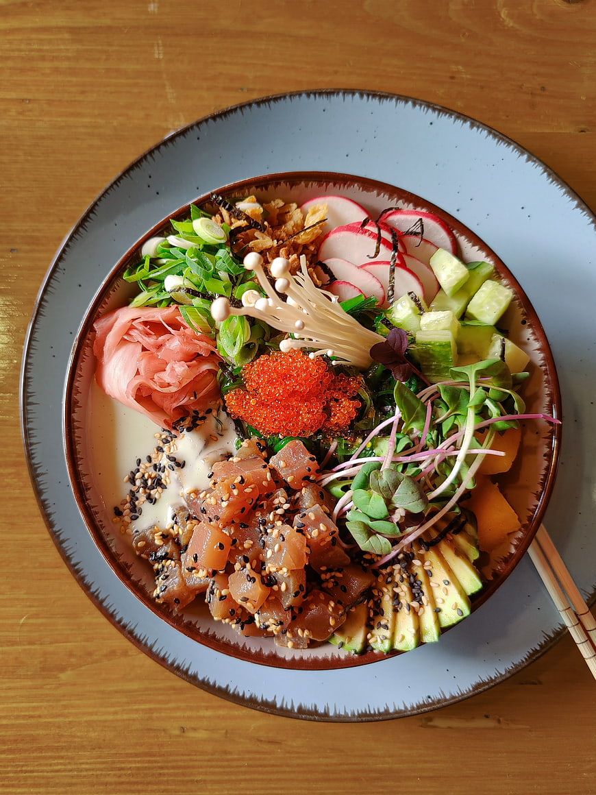 Overhead view of colorful tuna poke bowl with fresh toppings