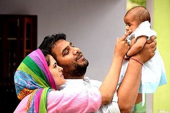 South Asian Family Portrait With Baby And Colorful Headscarf