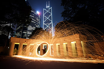Spinning Steel Wool Sparks in Front of Hong Kong IFC Tower at Night