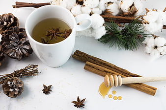 Cozy winter tea with honey, cinnamon, and pinecones