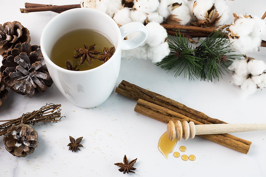 Cozy winter tea with honey, cinnamon, and pinecones