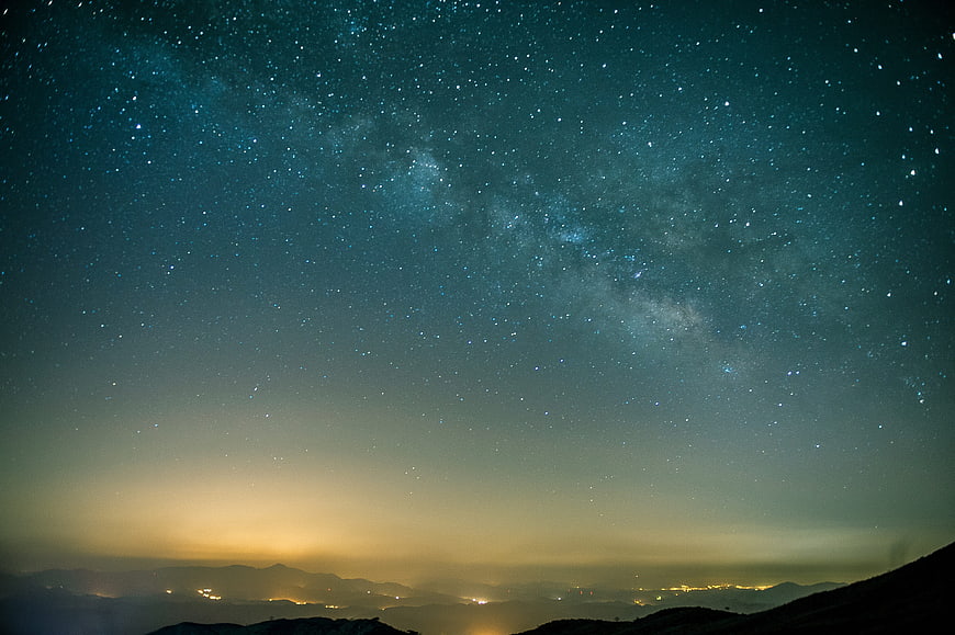 Milky Way Galaxy Over Mountainous Landscape At Night