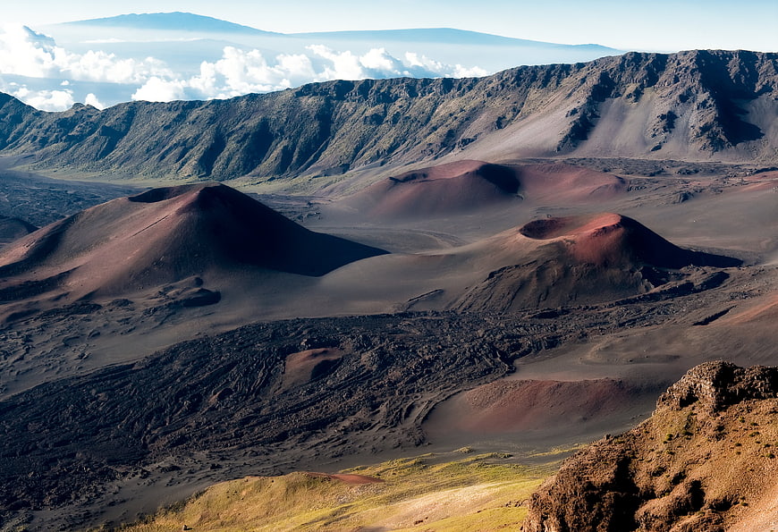 Vast volcanic crater landscape with red cinder cones and rugged terrain