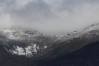 Snowy Mountain Peaks Shrouded in Mist and Fog