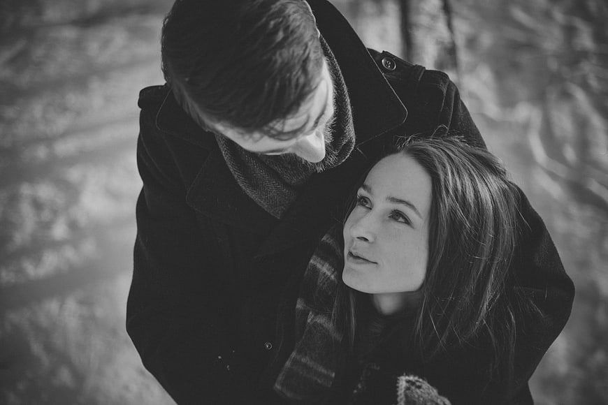 Black and white portrait of a couple embracing in winter