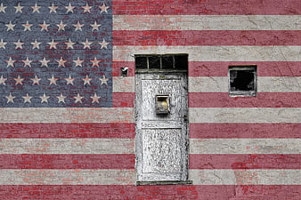 Weathered American Flag Mural on Brick Wall with Old Door