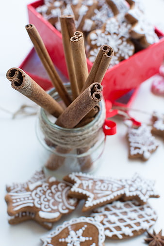 Cinnamon sticks in jar with Christmas gingerbread cookies