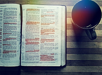 Open Bible with Coffee Cup on Wooden Table