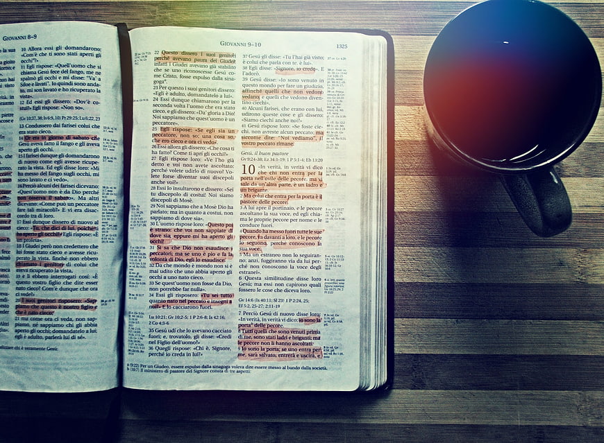 Open Bible with Coffee Cup on Wooden Table