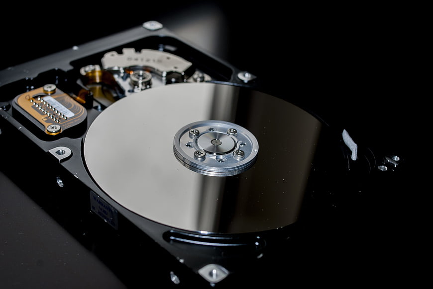 Close-up of Open Hard Disk Drive Platter and Actuator Arm
