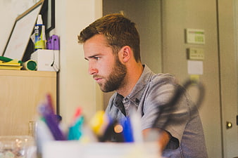Focused Bearded Man Working at Office Desk