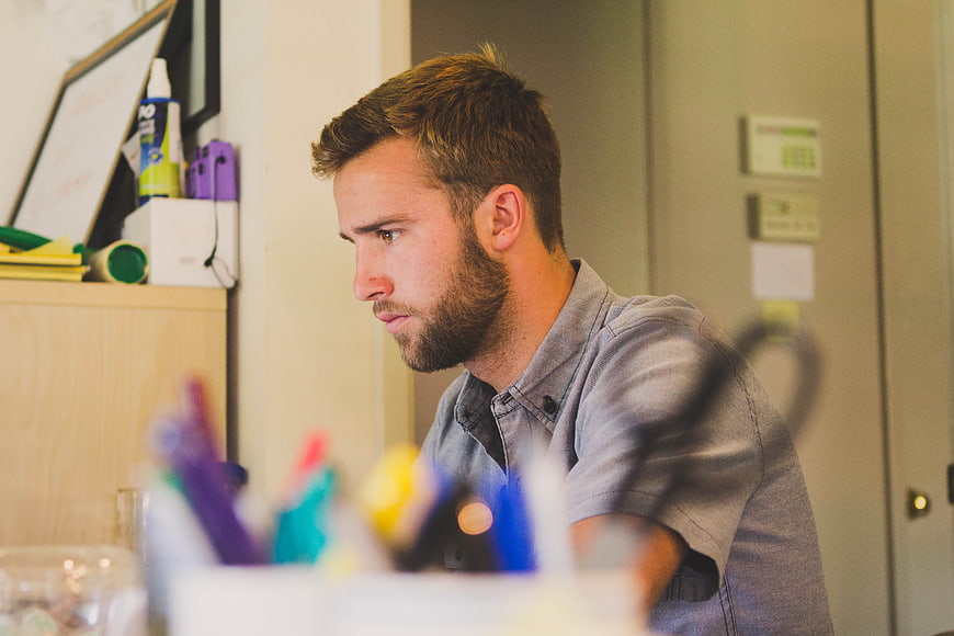 Focused Bearded Man Working at Office Desk