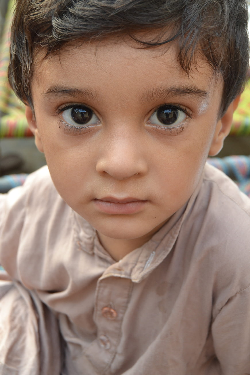 Close-up portrait of a young boy with intense eyes