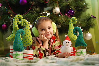 Cute Girl with Christmas Decorations and Snowman Toy