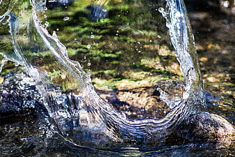 Dynamic Water Splash on Rocks in a River