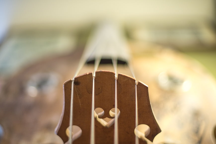 Close-up of vintage bass guitar headstock with strings