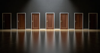 Conceptual row of wooden doors in dark hallway with spotlight