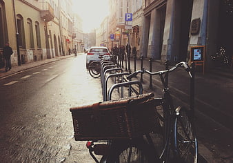 Vintage bicycle with wicker basket parked on European street