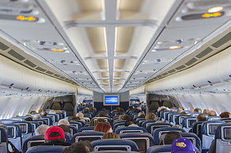 Interior view of a commercial airplane cabin with passengers