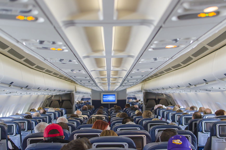 Interior view of a commercial airplane cabin with passengers