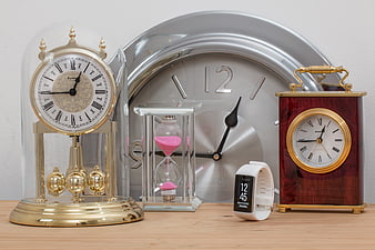 Collection of vintage and modern clocks on wooden table