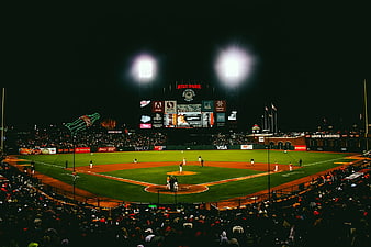 Night baseball game at AT&T Park with stadium lights and crowd