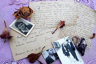 Vintage handwritten letters and old black and white photographs with dried roses