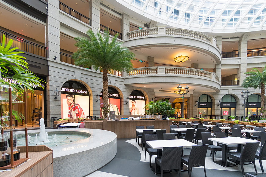 Luxury Shopping Mall Interior with Fountain and Cafe