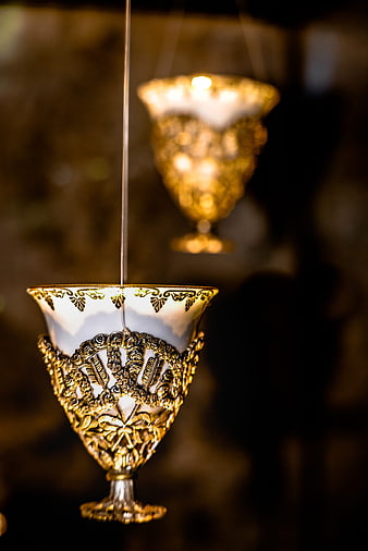 Hanging ornate gold and white porcelain goblet