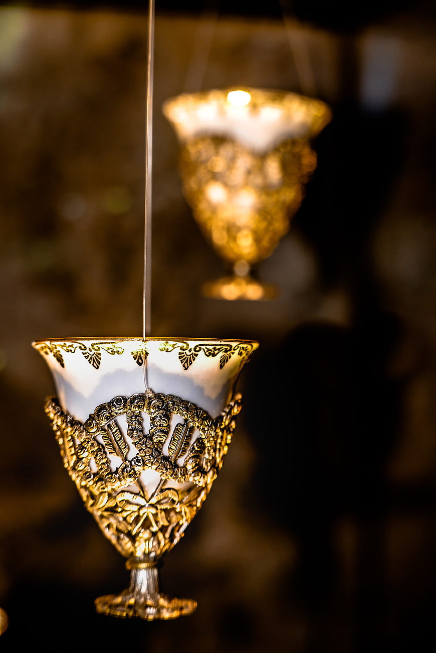 Hanging ornate gold and white porcelain goblet