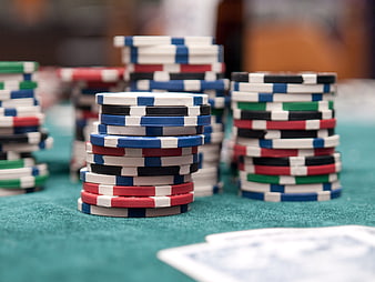 Stacks of poker chips on green felt table