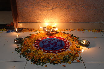 Traditional Indian Rangoli with Oil Lamps and Marigold Petals